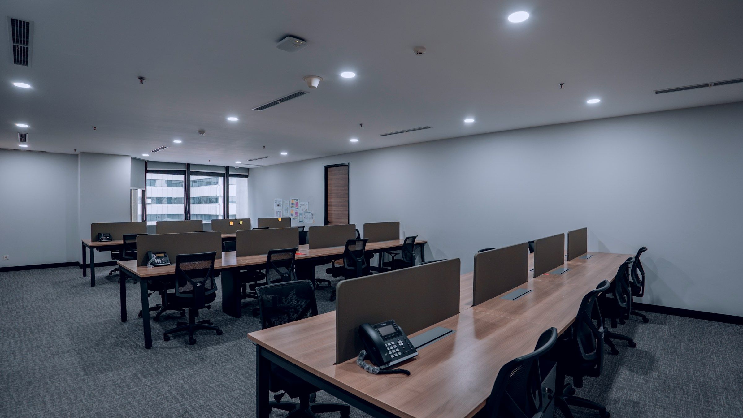Desk telephones on workstations in an open office